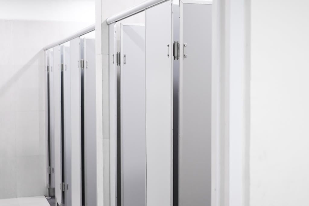 Clean and sleek public washroom with modern laminate partition cubicles.